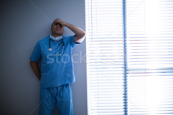 Depressed surgeon leaning against wall Stock photo © wavebreak_media