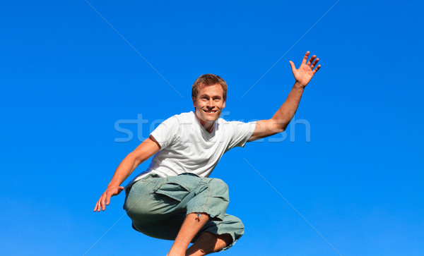 Young man jumping in the air Stock photo © wavebreak_media