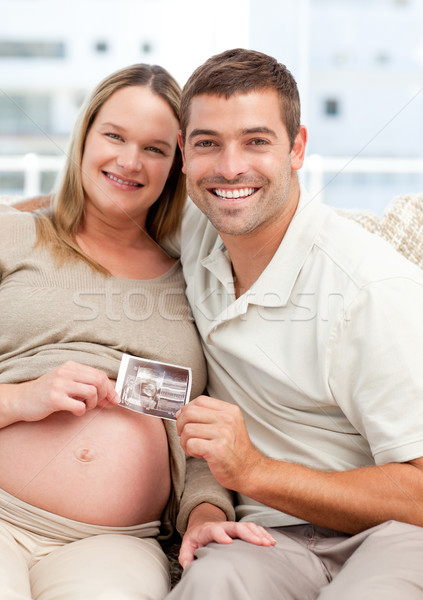 Proud future mom and dad showing an echography to the camera Stock photo © wavebreak_media