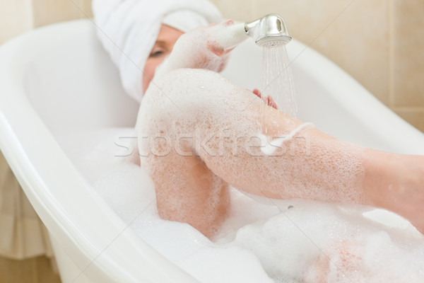 Smiling woman taking a bath with a towel on her head Stock photo © wavebreak_media