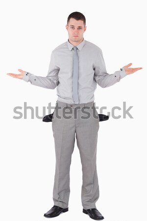 Portrait of a young businessman with empty pockets against a white background Stock photo © wavebreak_media