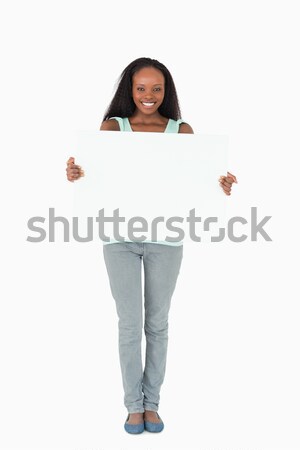 Smiling woman with placeholder on white background Stock photo © wavebreak_media