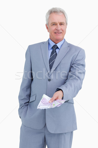 Mature tradesman with bank notes in his hand against a white background Stock photo © wavebreak_media