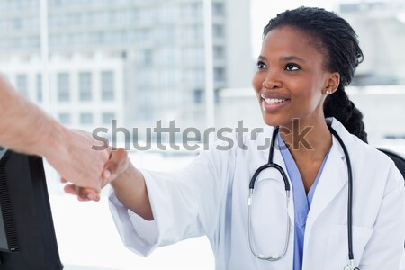 Mosolyog női orvos kezet fog iroda nő Stock fotó © wavebreak_media