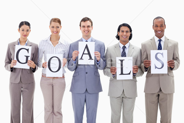 Stock photo: Business team holding the letters of GOALS against white background