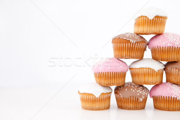 Pyramid of many muffins with icing sugar against a white background Stock photo © wavebreak_media
