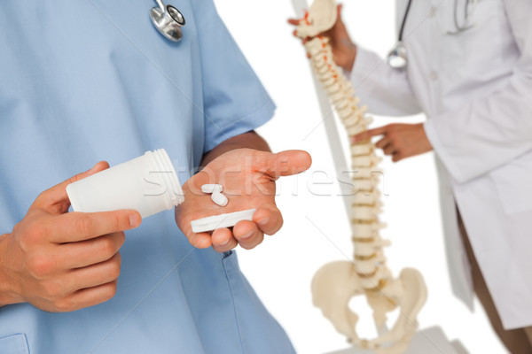 Mid section of doctors with pills and skeleton model Stock photo © wavebreak_media