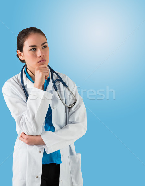 Serious doctor in lab coat thinking with hand on chin Stock photo © wavebreak_media