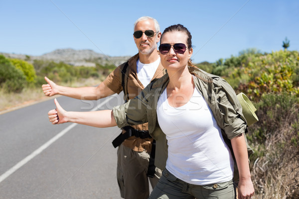 Hitch hiking couple standing on the side of the road with thumb  Stock photo © wavebreak_media