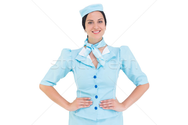 Pretty air hostess smiling at camera Stock photo © wavebreak_media