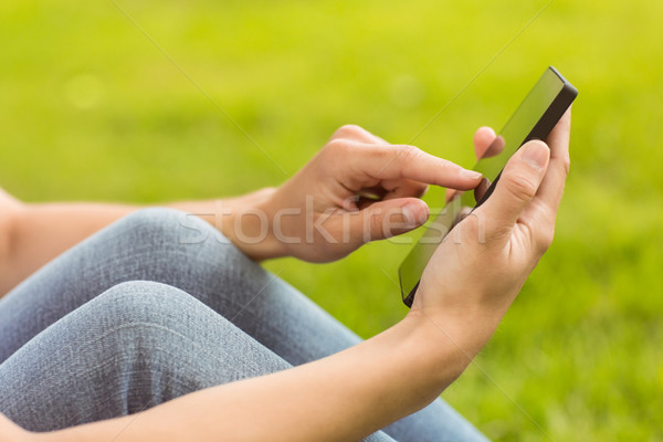 Mid section of a pretty redhead texting Stock photo © wavebreak_media