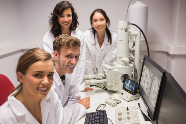 Biochemistry students using large microscope and computer Stock photo © wavebreak_media