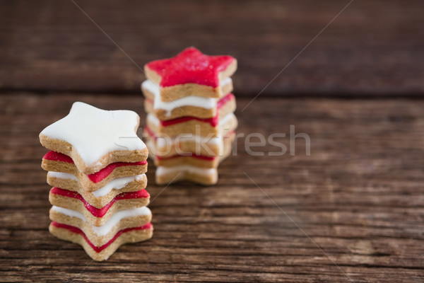 Red and white sugar cookies stacked on wooden table Stock photo © wavebreak_media