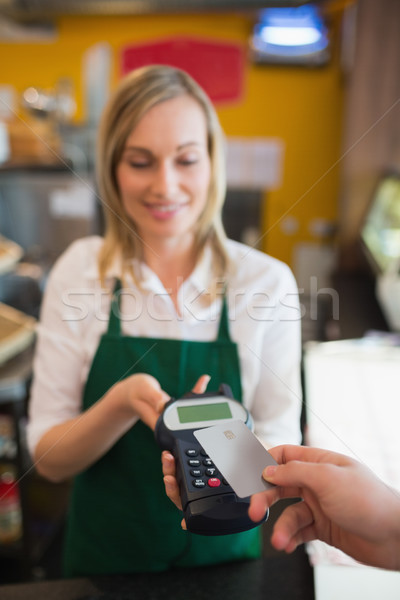 Female worker accepting payment through credit card Stock photo © wavebreak_media