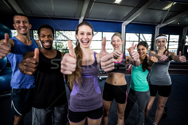 Smiling fitness class posing together with thumbs up  Stock photo © wavebreak_media
