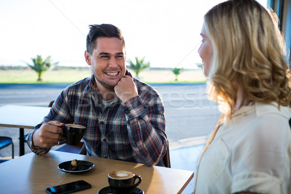 Smiling couple interacting with each other while having cup of c Stock photo © wavebreak_media