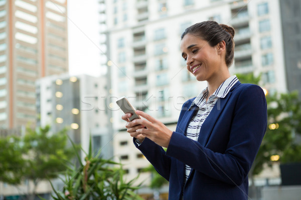 Stock fotó: üzlet · igazgató · mobiltelefon · mosolyog · város · épületek