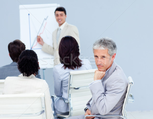 Stock photo: Confident businessman looking at the camera at a conference