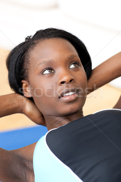 Stock photo: Ethniic woman in gym outfit doing sit-ups 
