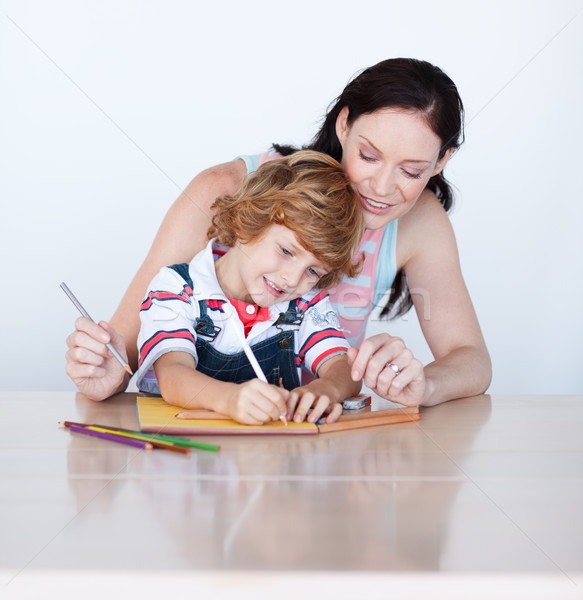 Mother helping her son to draw at home  Stock photo © wavebreak_media