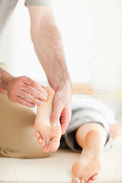 Man massaging a woman's feet in a room Stock photo © wavebreak_media