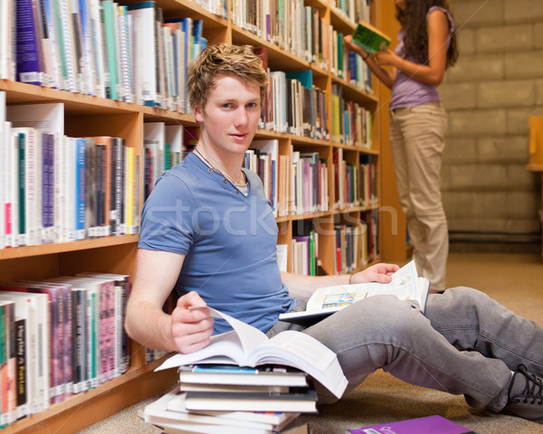 Male student doing research while his classmate is reading in a library Stock photo © wavebreak_media