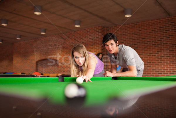 Man teaching pool to his girlfriend with the camera focus on the models Stock photo © wavebreak_media