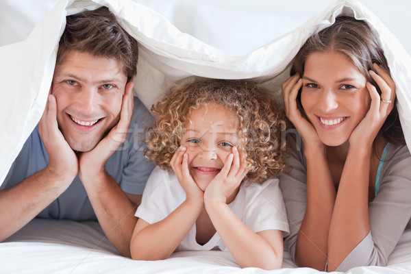 Family posing under a duvet while looking at the camera Stock photo © wavebreak_media