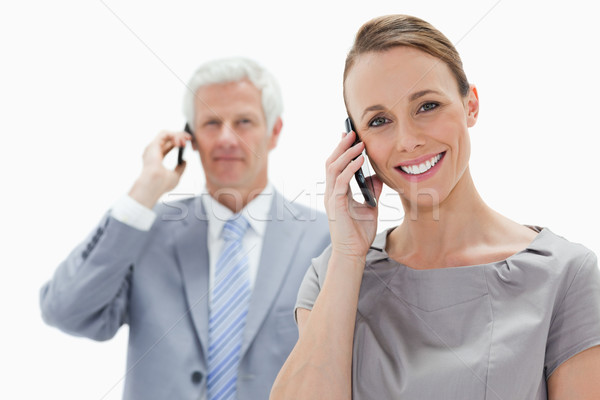 Close-up of a smiling woman making a call with a white hair man in background Stock photo © wavebreak_media