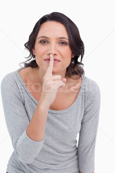 Close up of young woman asking for silence against a white background Stock photo © wavebreak_media