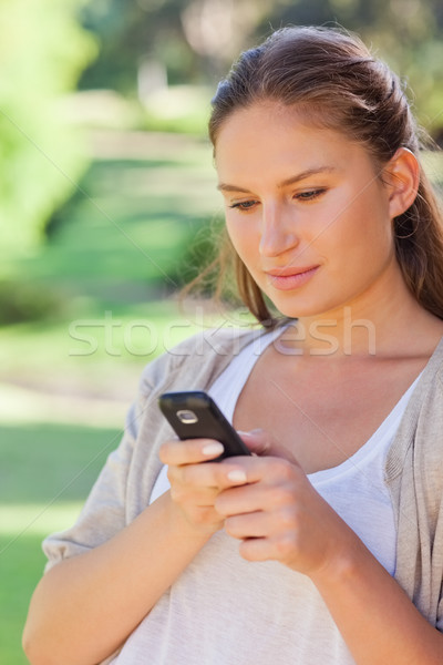 Close up of woman writing a text message in the park Stock photo © wavebreak_media