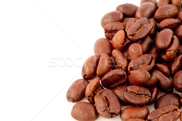 Many dark blurred coffee seeds laid out together against a white background Stock photo © wavebreak_media