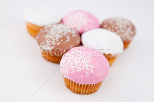 Stock photo: Blurred muffins placed in pyramid against a grey background