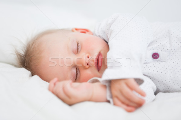 Cute baby sleeping while extending her arms in a room Stock photo © wavebreak_media