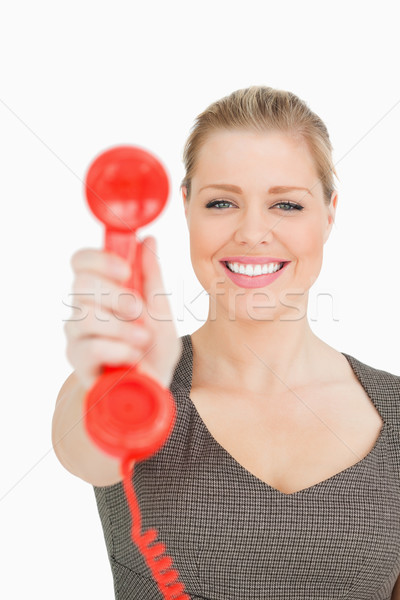Pretty woman showing a retro phone against white background Stock photo © wavebreak_media