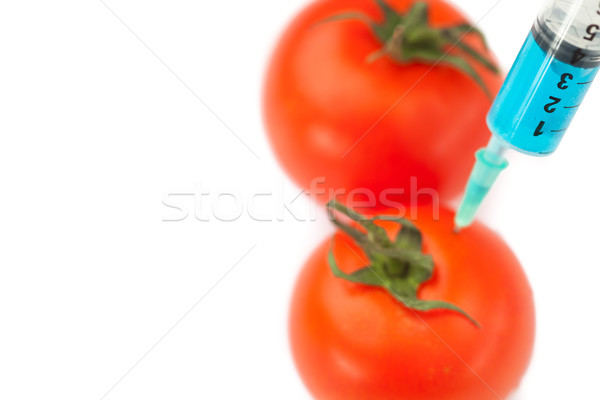 Syringe pricking tomato against a white background Stock photo © wavebreak_media