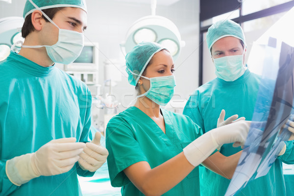 Surgical team analysing a X-ray in an operating theatre Stock photo © wavebreak_media