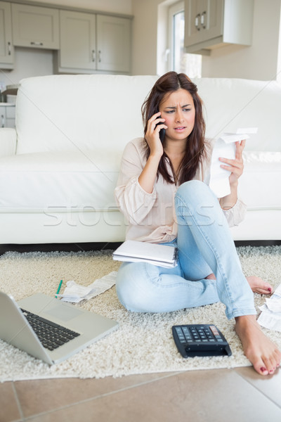 Woman calling while calculating bills with laptop Stock photo © wavebreak_media