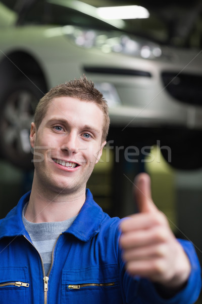 Handsome car mechanic gesturing thumbs up Stock photo © wavebreak_media