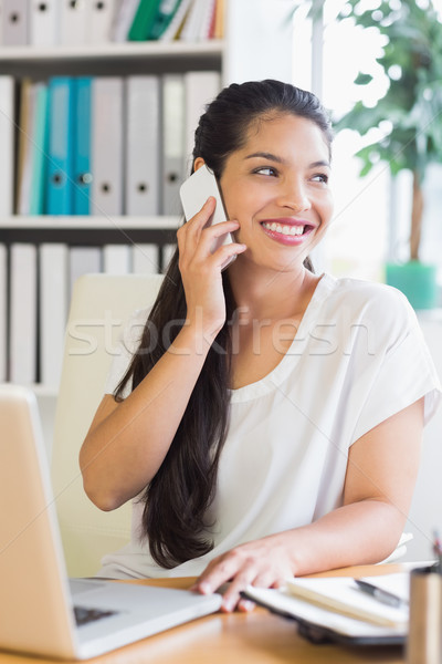 Businesswoman using cell phone at desk  Stock photo © wavebreak_media