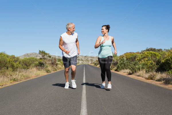 Fit couple running on the open road together Stock photo © wavebreak_media