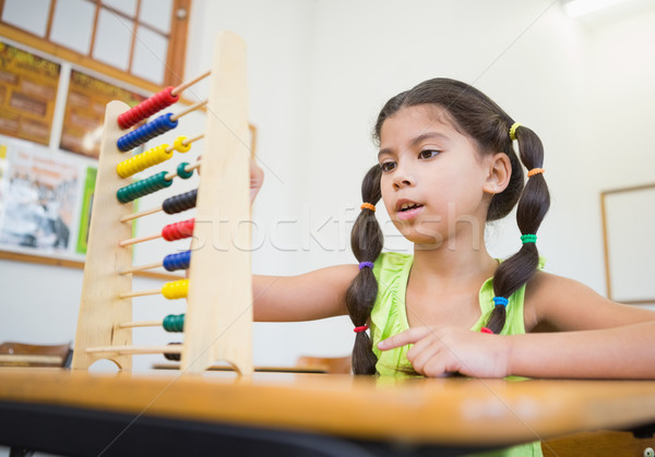 Cute pupil using abacus in classroom Stock photo © wavebreak_media
