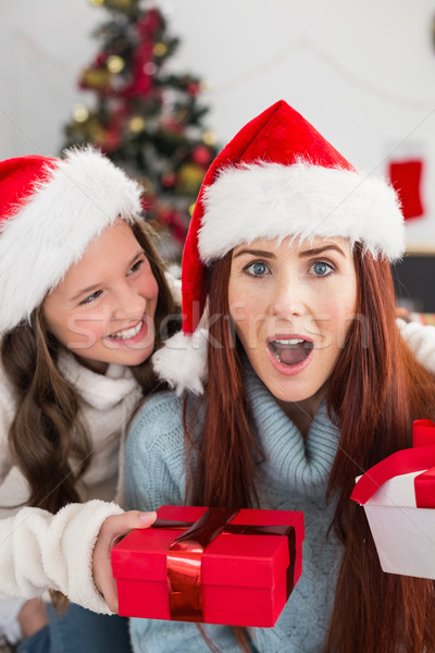 Festive mother and daughter exchanging gifts Stock photo © wavebreak_media