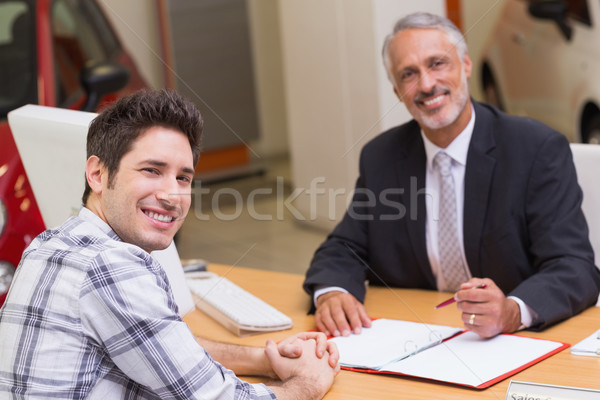 Smiling businessman and customer looking at camera Stock photo © wavebreak_media