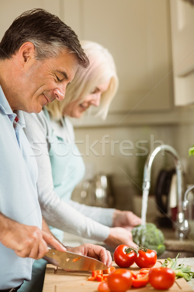 Stock photo: Happy mature couple preparing vegetables