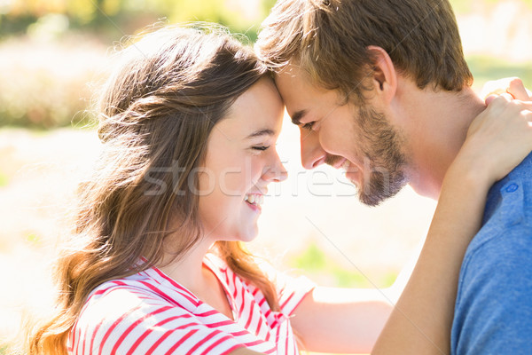 Stock photo: Cute coupe smiling at each other in park 
