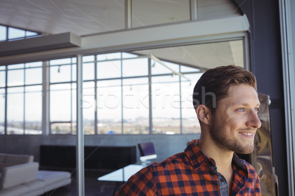 Smiling businessman looking through window Stock photo © wavebreak_media