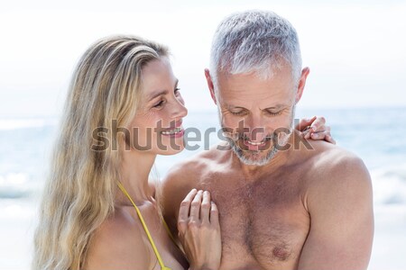 Stock photo: Happy woman applying sunscream on smiling man face at beach