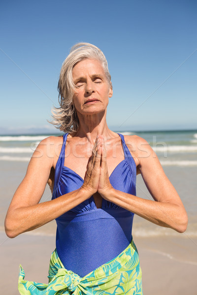 Close up of woman with hands clasped standing against clear sky Stock photo © wavebreak_media