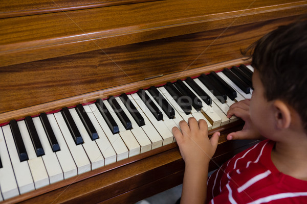 Close up of boy playing piano in classroom Stock photo © wavebreak_media